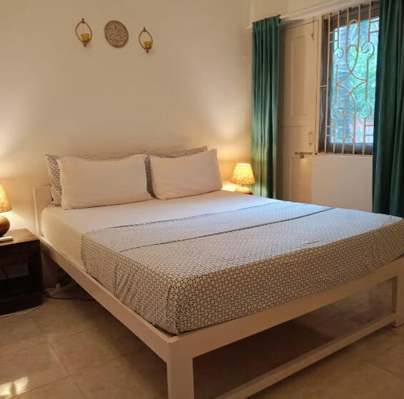 Cozy Calangute beach apartment bedroom with garden view